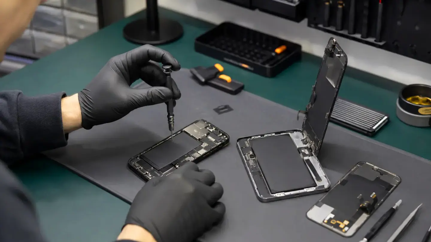 Phone battery replacement Bristol Technician replacing a smartphone battery safely on an anti-static workbench